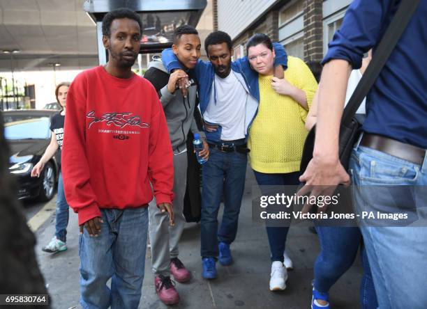 Local resident is carried to receive some medical aid at a community centre close to a fire that has engulfed the 24-storey Grenfell Tower in west...