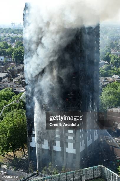 Firefighter team extinguish a huge fire engulfed the 24 storey residential Grenfell Tower block in Latimer Road, West London in the early hours of...