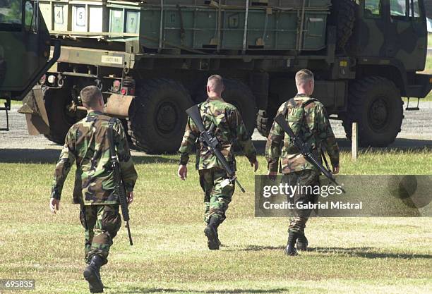 Soldiers armed with M-16 rifles secure the cargo brought by a C-17 Globemaster III U.S. Cargo plane January 30, 2002 in Zamboanga City, southern...