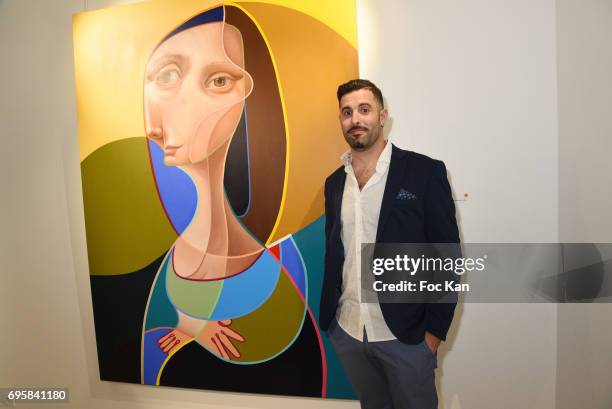 Painter Belin poses with his work during Belin Exhibition Preview Cocktail at 24 Beaubourg galerie on June13, 2017 in Paris, France.