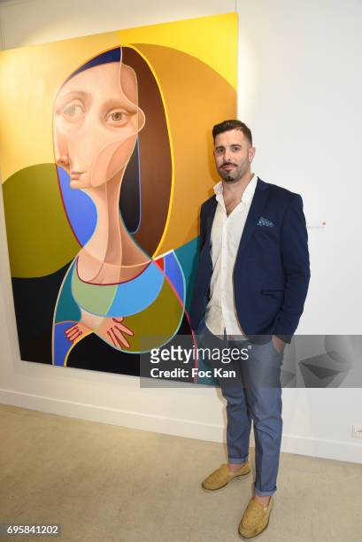 Painter Belin poses with his work during Belin Exhibition Preview Cocktail at 24 Beaubourg galerie on June13, 2017 in Paris, France.