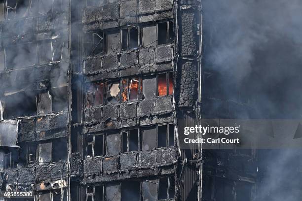 Smoke continues to rise from the burning 24 storey residential Grenfell Tower block in Latimer Road, West London on June 14, 2017 in London, England....