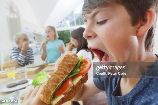 children eating sandwiches they have made themselves - open day 13 stock pictures, royalty-free photos & images