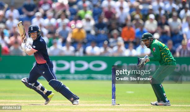 England batsman Eoin Morgan hits out watched by Sarfraz Ahmed during the ICC Champions Trophy semi final between England and Pakistan at SWALEC...