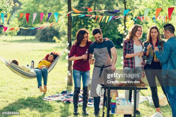 friends enjoying a barbecue among nature - public park worker stock pictures, royalty-free photos & images