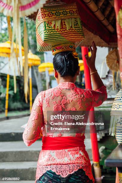 editorial: ubud, indonesia -march 02, 2016: balinese woman in traditional clothes  carrying ceremonial box with offerings on her head during balinese new year or nyepi day celebrations - bali women tradition head stock pictures, royalty-free photos & images