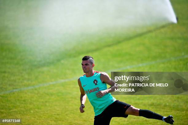 Portugal's defender Pepe warms up during a training session at "Cidade do Futebol" training camp in Oeiras, outskirts of Lisbon, on June 14, 2017...