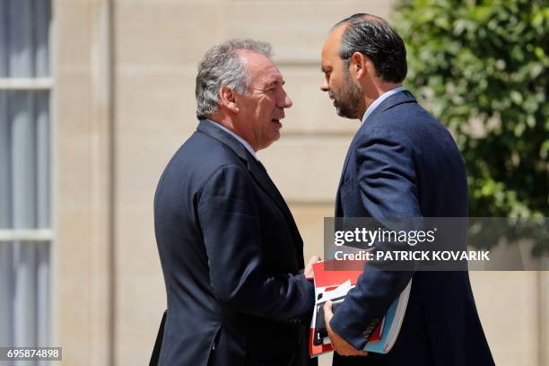 French Prime Minister Edouard Philippe and French Minister of Justice Francois Bayrou speak as they leave a cabinet meeting on June 14, 2017 at the...