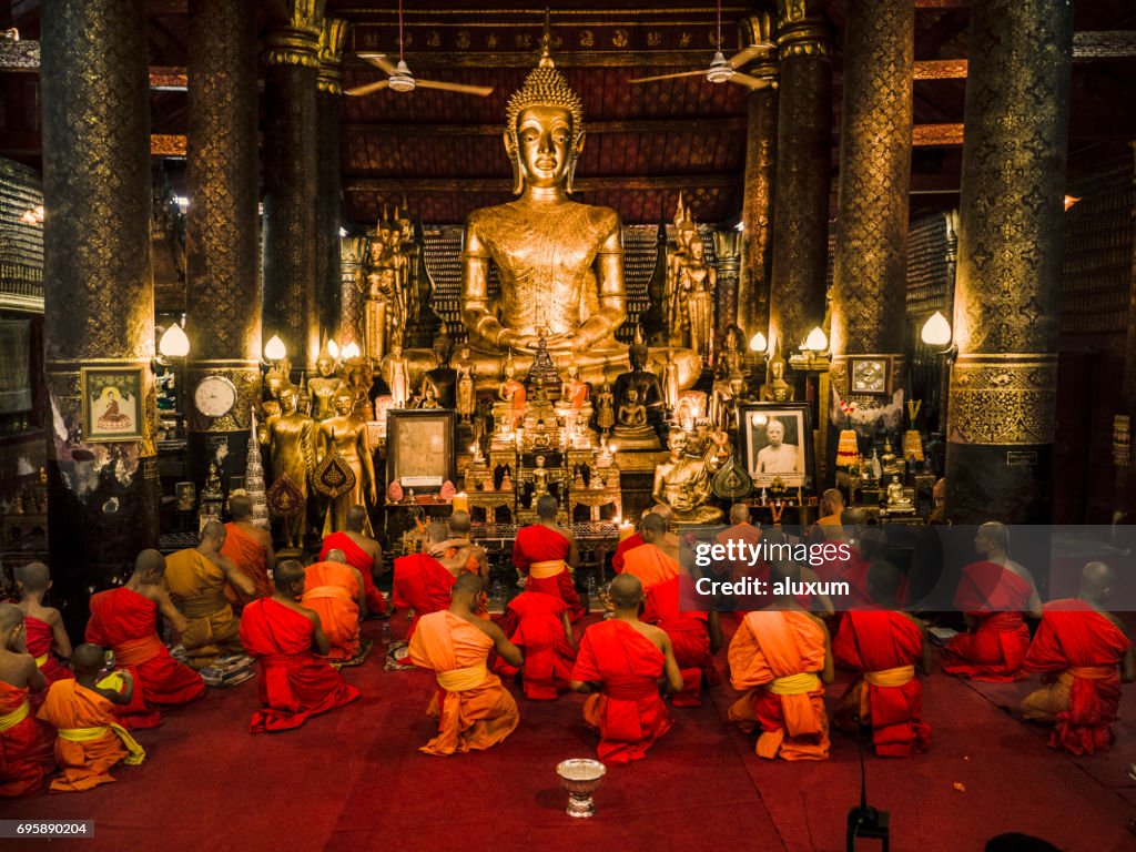 Buddhist monks praying in Wat Mail during Vesak Luang Prabang Laos