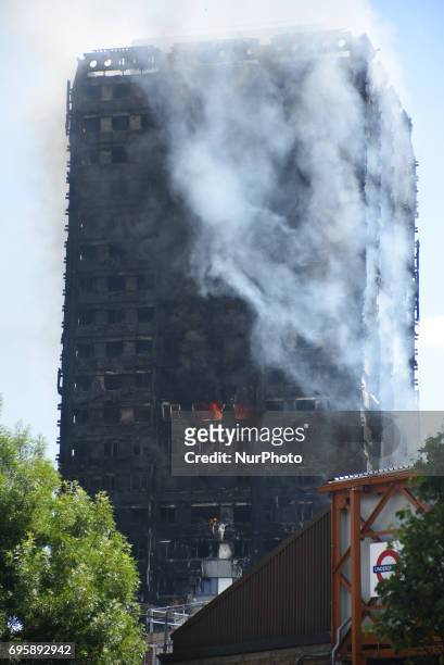 Smoke and flames billows from Grenfell Tower as firefighters attempt to control a blaze at a residential block of flats at Ladbroke Grove, London on...