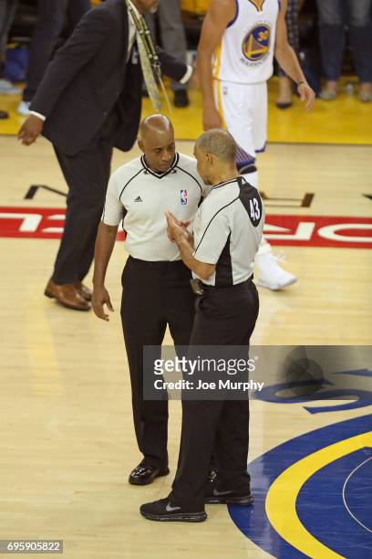 Referees, Derrick Stafford and Dan Crawford discuss a call in Game Five of the 2017 NBA Finals between the Cleveland Cavaliers and the Golden State...