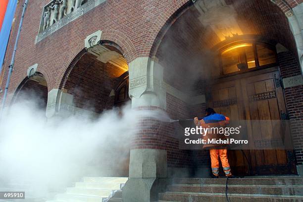 Worker cleans the entrance of the "Beurs van Berlage" building January 30, 2002 in Amsterdam, Netherlands as the city prepares for a royal wedding....