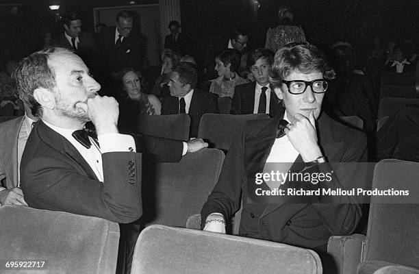 French fashion designer Yves Saint Laurent and his partner Pierre Bergé attend the first play by the writer François-Marie Banier at the Modern...