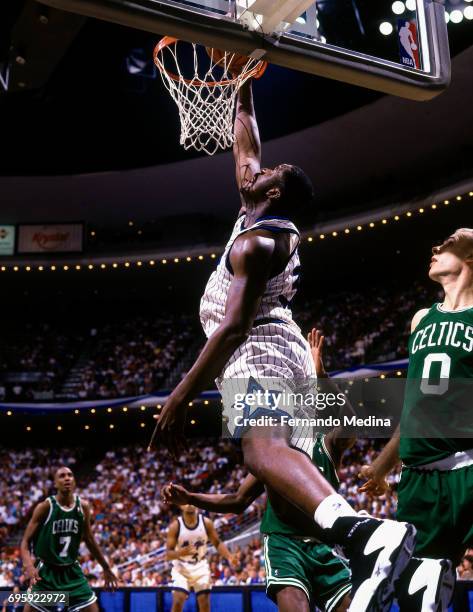 Tree Rollins of the Orlando Magic dunks against the Boston Celtics during a game played on April 30, 1995 at Orlando Arena in Orlando, Florida. NOTE...