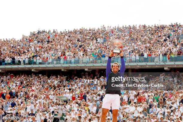 French Open Tennis Tournament - Day Fifteen. Rafael Nadal of Spain with the trophy in front of an amazing back drop of fans at Roland Garros after...