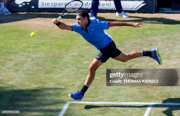 Switzerland's Roger Federer returns the ball to Germany's Tommy Haas in their round of sixteen match at the ATP Cup tennis tournament in Stuttgart,...