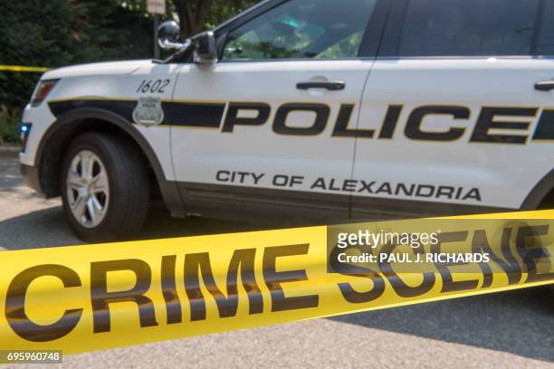 Police car secures the crime scene near a baseball field after a shooting in Alexandria, Virginia on June 14, 2017. Several people including a top...