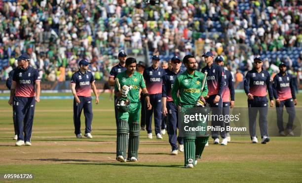 Babar Azam and Mohammad Hafeez of Pakistan lead the players off after the ICC Champions Trophy match between England and Pakistan at Swalec stadium...