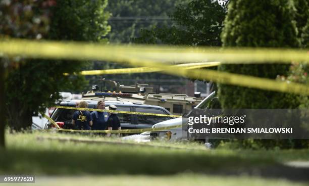 Members of the FBI gather after a shooting during a practice of the Republican congressional baseball at Eugene Simpson Statium Park June 14, 2017 in...
