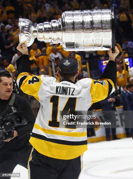 Chris Kunitz of the Pittsburgh Penguins celebrates with the Stanley Cup trophy after defeating the Nashville Predators 2-0 in Game Six of the 2017...