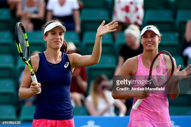 Yanina Wickmayer of Belgium and Johanna Konta of Great Britain celebrate their victory in their Women's doubles first round match against Chia-Jung...