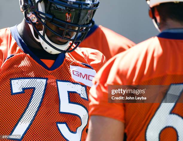 Denver Broncos offensive tackle Menelik Watson looks on during drills at mandatory mini camp on June 14, 2017 in Englewood, Colorado at Dove Valley.