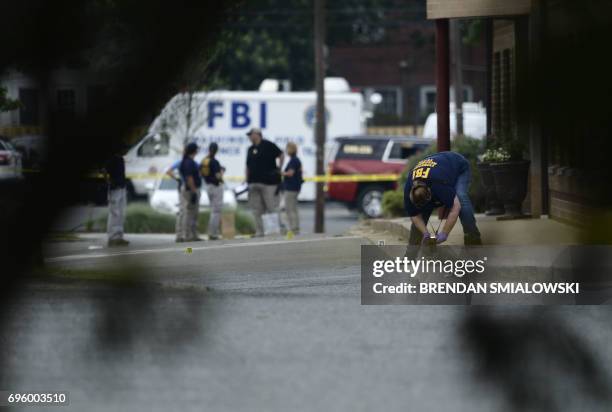 Member of the FBI inspects the crime scene after a shooting during a practice of the Republican congressional baseball at Eugene Simpson Statium Park...