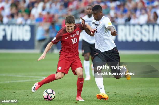 United States midfielder Christian Pulisic dribbles the ball as he battles with Trinidad & Tobago defender Sheldon Bateau during the FIFA 2018 World...