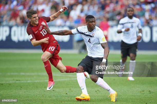 United States midfielder Christian Pulisic dribbles the ball as he battles with Trinidad & Tobago defender Sheldon Bateau during the FIFA 2018 World...