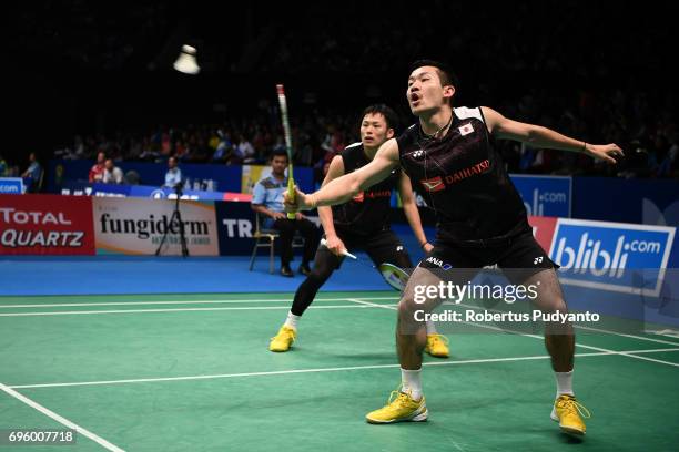 Takeshi Kamura and Keigo Sonoda of Japan compete against Chen Hung Ling and Wang Chi-Lin of Chinese Taipei during Mens Double Round 2 match of the...