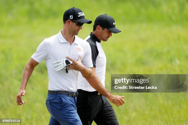 Adam Scott of Australia and Jason Day of Australia walk across the course during a practice round prior to the 2017 U.S. Open at Erin Hills on June...