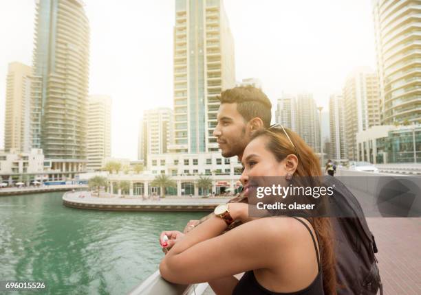 young couple on vacation in dubai marina - lypseuae2015 stock pictures, royalty-free photos & images