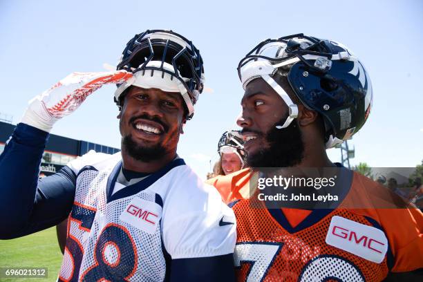 Denver Broncos outside linebacker Von Miller gives a salute as running back Bernard Pierce looks at him as they visit with the U.S. Air Force...