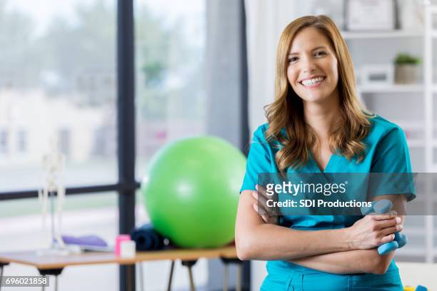 portrait of beautiful physical therapist - gym excercise ball stock pictures, royalty-free photos & images
