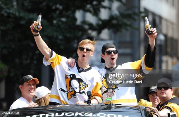 Olli Maatta and Justin Schultz of the Pittsburgh Penguins ride in the Victory Parade and Rally on June 14, 2017 in Pittsburgh, Pennsylvania.