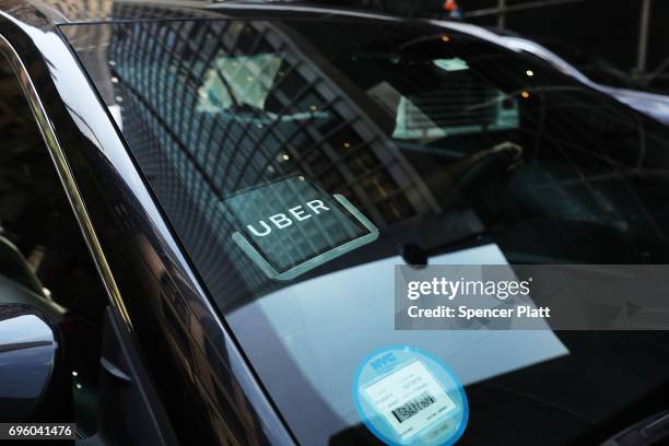 An Uber car waits for a client in Manhattan a day after it was announced that Uber co-founder Travis Kalanick will take a leave of absence as chief...