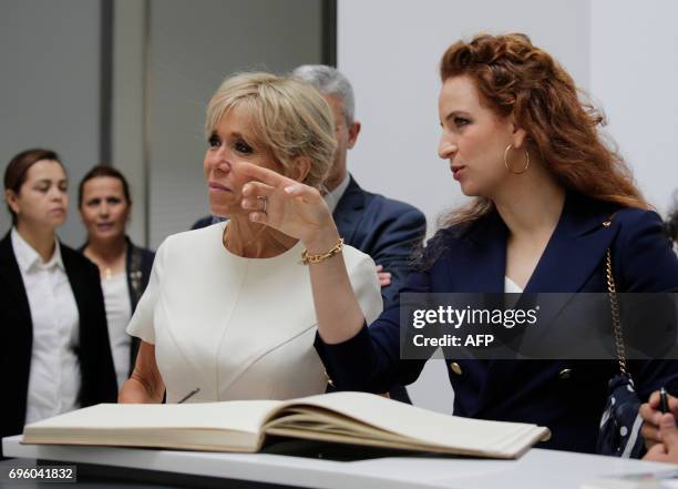 Morocco's Princess Lalla Salma speaks to French president's wife Brigitte Macron during their visit to the Picasso exhibition at the National Museum...