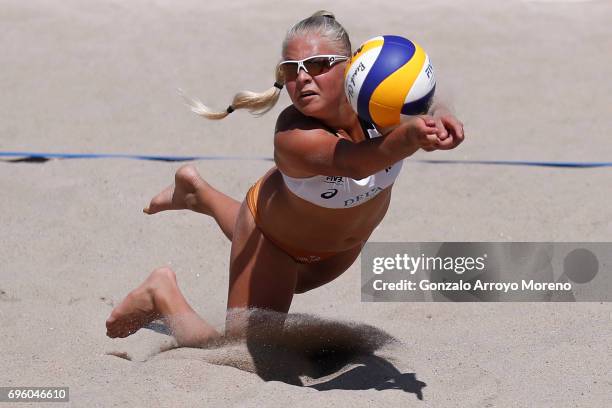 Raisa Schoon from the Netherlands dives for the ball during her qualification match with partner Emi van Driel against Bakhtygul Samalikkova and...