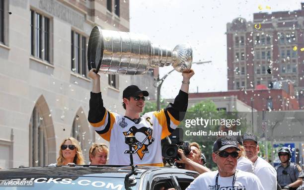 Sidney Crosby of the Pittsburgh Penguins hoists the Stanley Cup during the Victory Parade and Rally on June 14, 2017 in Pittsburgh, Pennsylvania.