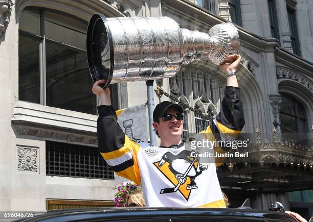 Sidney Crosby of the Pittsburgh Penguins hoists the Stanley Cup during the Victory Parade and Rally on June 14, 2017 in Pittsburgh, Pennsylvania.