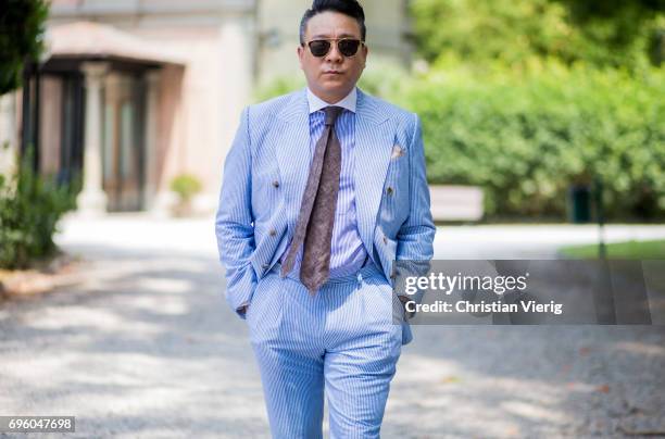 Guest wearing a light blue suit is seen during Pitti Immagine Uomo 92. At Fortezza Da Basso on June 14, 2017 in Florence, Italy.