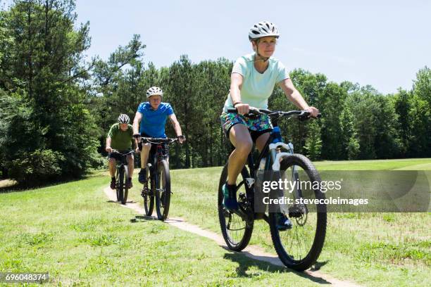 friends biking - cycling shorts stock pictures, royalty-free photos & images