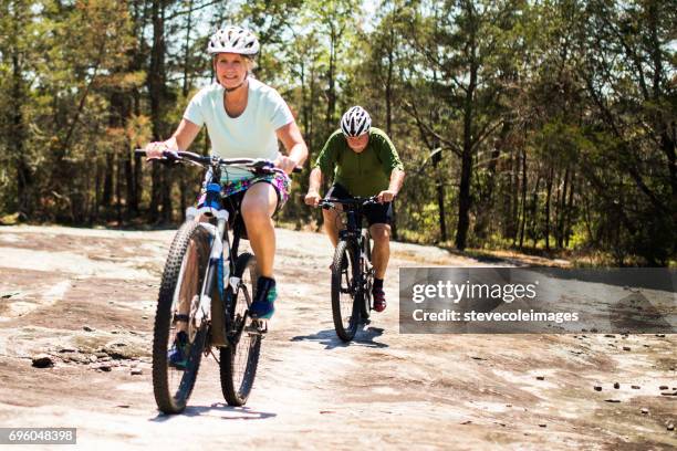 woman on mountain bike - cycling shorts stock pictures, royalty-free photos & images