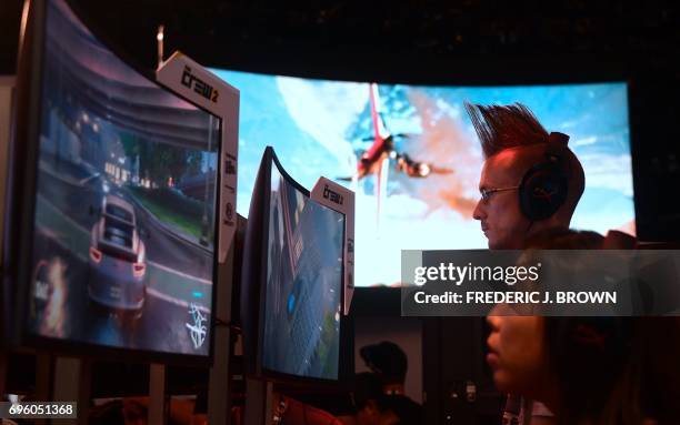 Gaming fans play Ubisoft's "The Crew 2" on day two of E3 2017, the three day Electronic Entertainment Expo at the Los Angeles Convention Center in...