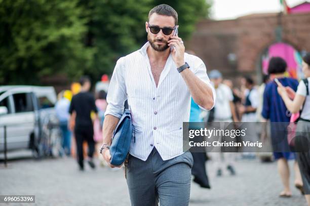 Guest wearing a white striped vest is seen during Pitti Immagine Uomo 92. At Fortezza Da Basso on June 14, 2017 in Florence, Italy.