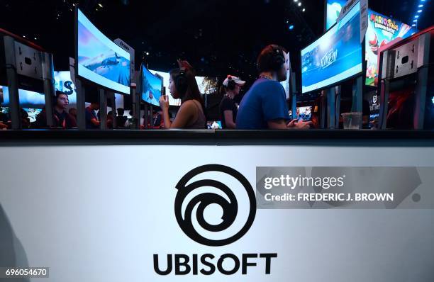 Gaming fans play "The Crew 2" from Ubisoft on day two of E3 2017, the three day Electronic Entertainment Expo at the Los Angeles Convention Center in...