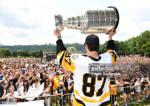 Sidney Crosby of the Pittsburgh Penguins carries the Stanley Cup during the Pittsburgh Penguins Victory Parade And Rally on June 14, 2017 in...