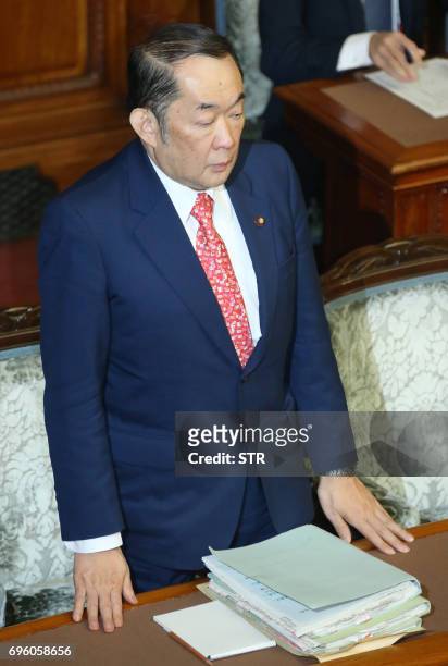 Justice Minister Katsutoshi Kaneda stands to accept the passage of the anti-terror law while attending the upper house of parliament in Tokyo on June...
