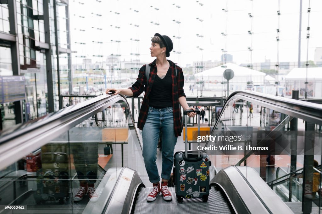 A Backpacker Traveling Through A Large Train Station