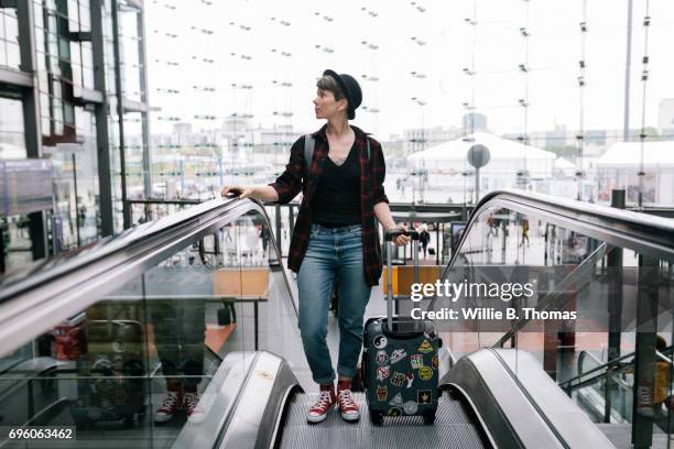 a backpacker traveling through a large train station - leanincollection stock pictures, royalty-free photos & images